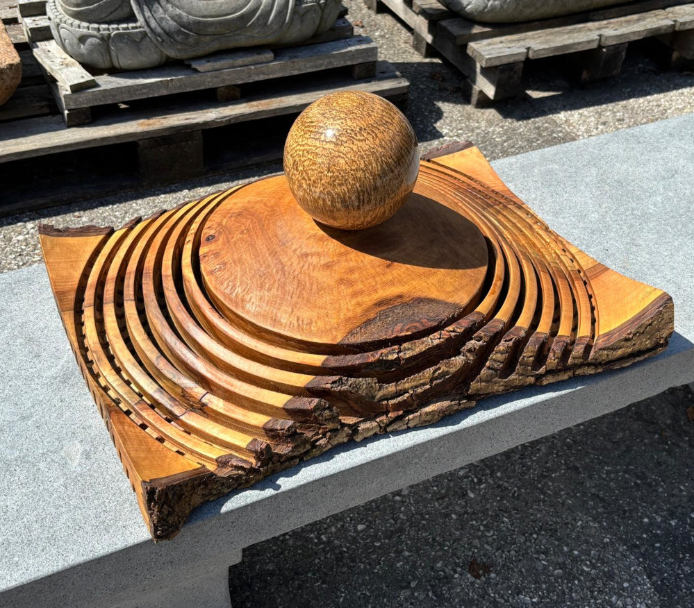 Holzskulptur mit steinkugel